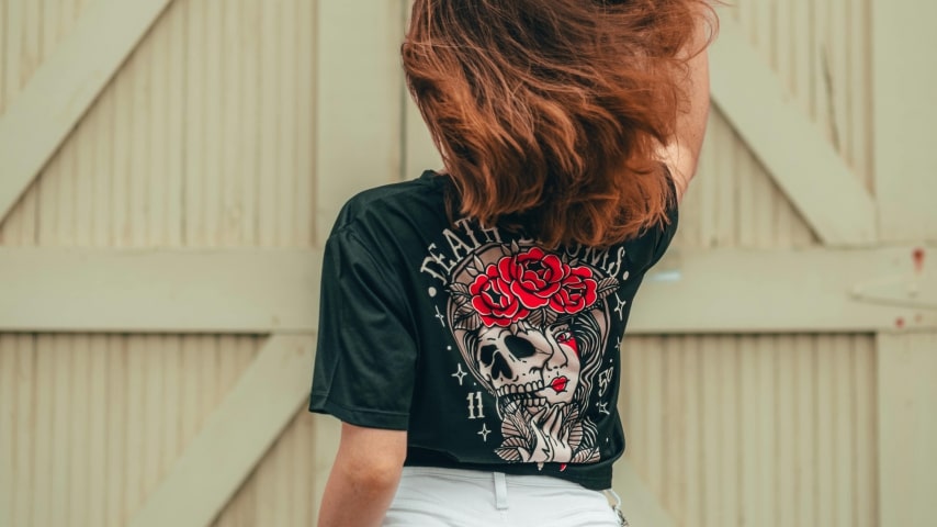 Start an eCommerce business with Printify A woman wearing a dark custom t-shirt with a back print.