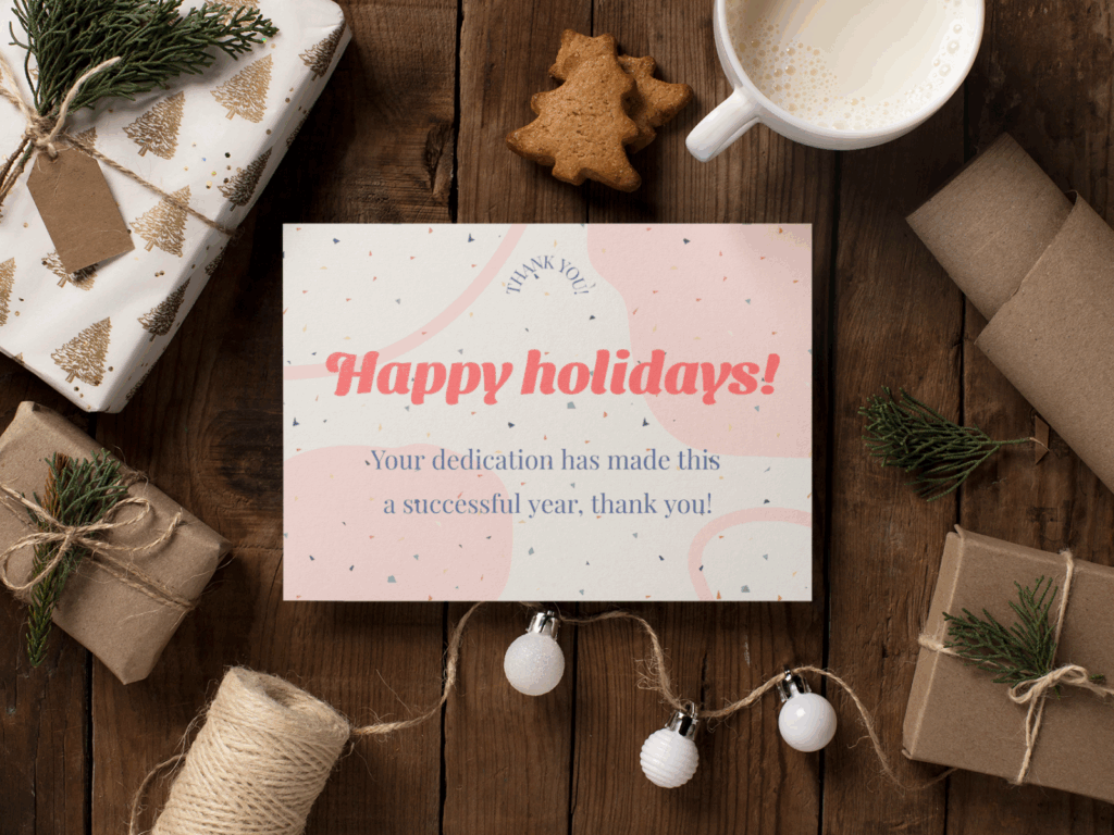 03 Business holiday card messages for employees and clients Mockup of a holiday greeting card featuring festive designs and colors, displayed on a wooden surface.