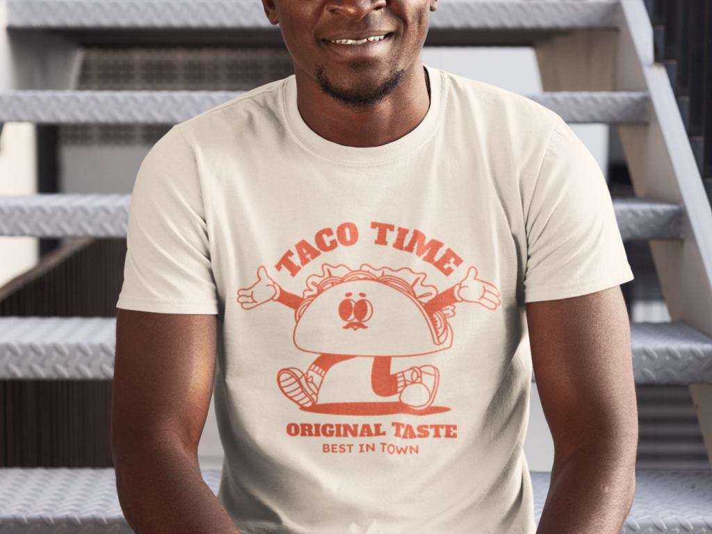 04 Nostalgia and retro aesthetics Man sitting on stairs wearing a light-colored t-shirt with a cheerful taco cartoon and text "Taco Time, Original Taste, Best in Town".