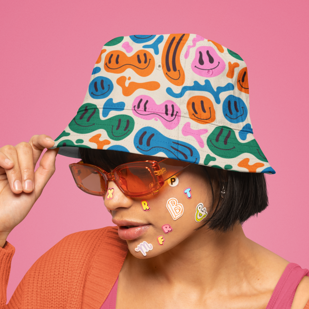 Hats and beanies A woman in a custom bucket hat on a pink background.