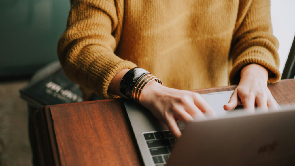 How to apply for a business license A woman typing on a laptop keyboard.