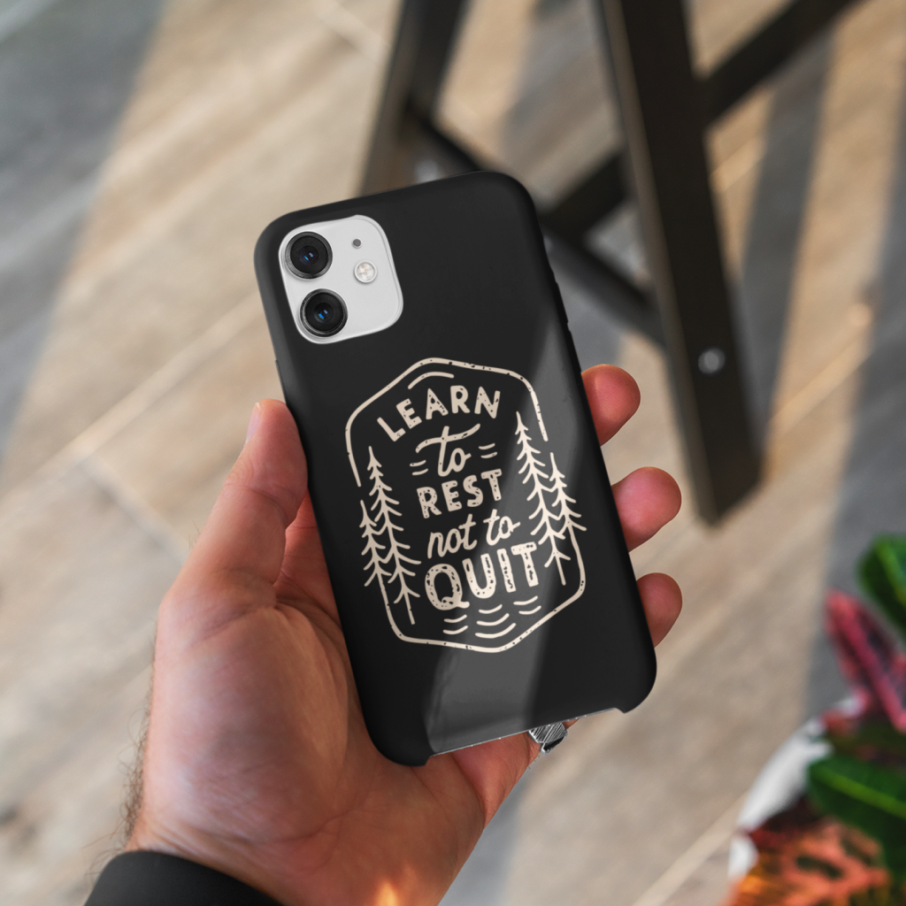 Personalized phone cases A custom black phone case with a “Learn to rest not to quit” print with illustrations.