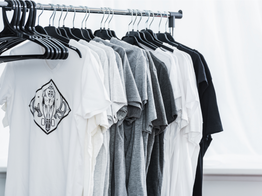 Start custom t shirt printing with Printify Multiple custom t-shirts on hangers.