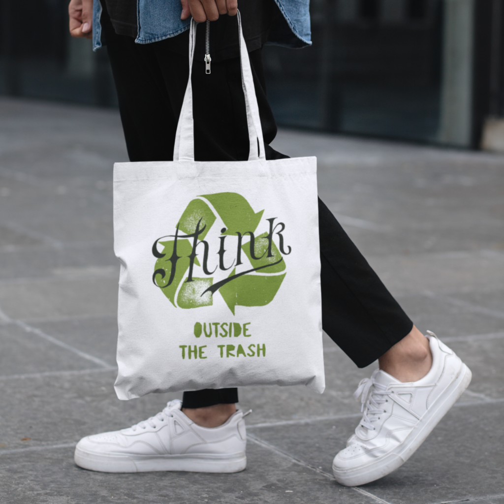 Tote bags A person walking in the streets, wearing a custom “Think outside the trash” tote bag.