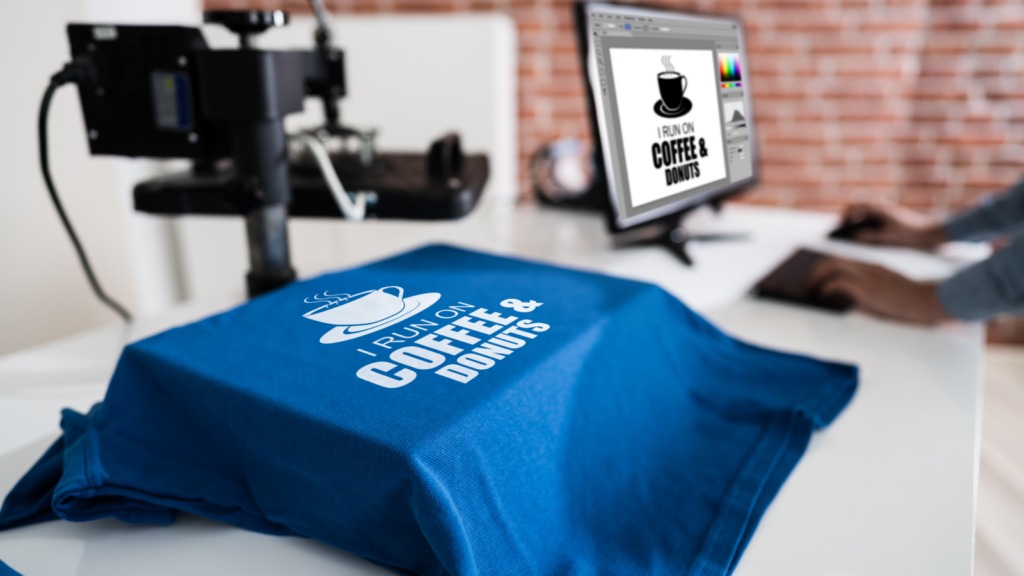 Use Print on Demand A coffee logo shirt is placed on a desk, highlighting a blend of comfort and passion for coffee culture.