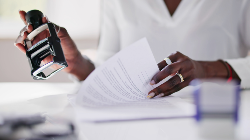 What is a business license Woman’s hands listing and stamping papers.